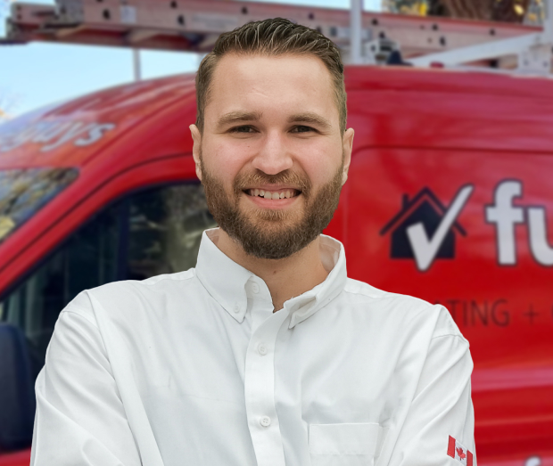 Smiling furnaceguys technician standing confidently in front of their green service van, wearing their white issued uniform.