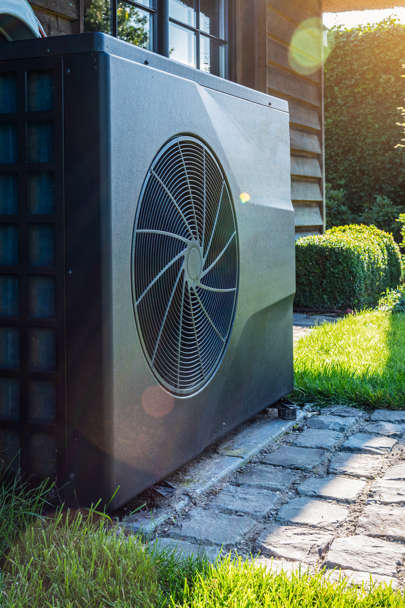 Full inverter heat pump near house in garden. Full inverter heat pump near house in garden.